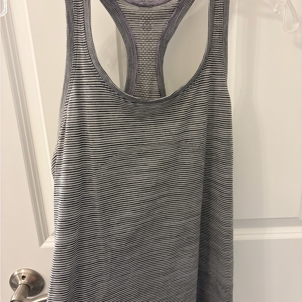 lululemon athletica Black and White Striped Racerback Tank
Swiftly hip length